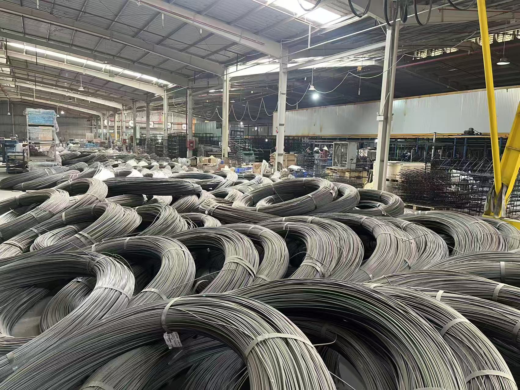 Coils of steel wire stored on the VTS Spring factory floor