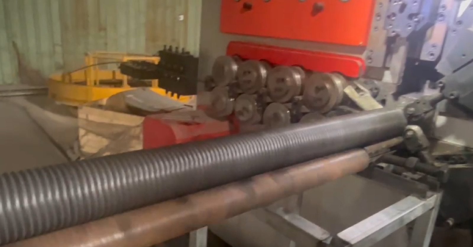 Garage door spring being formed on coiling equipment